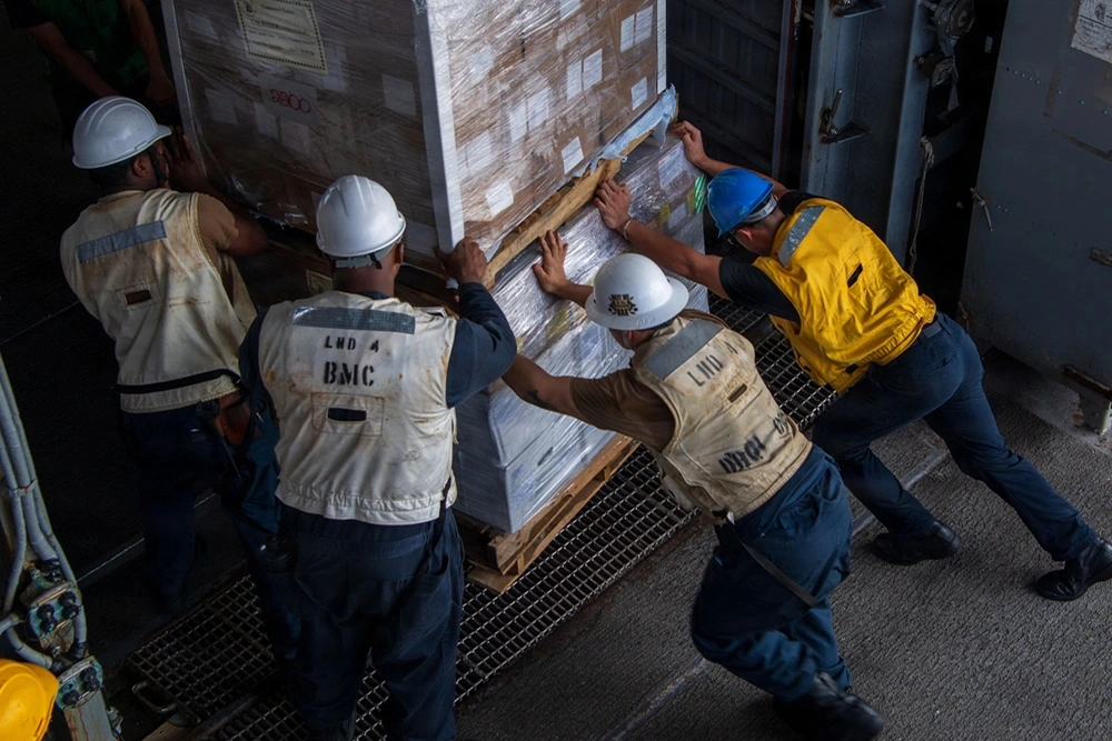 Image of U.S. Sailors moving supplies